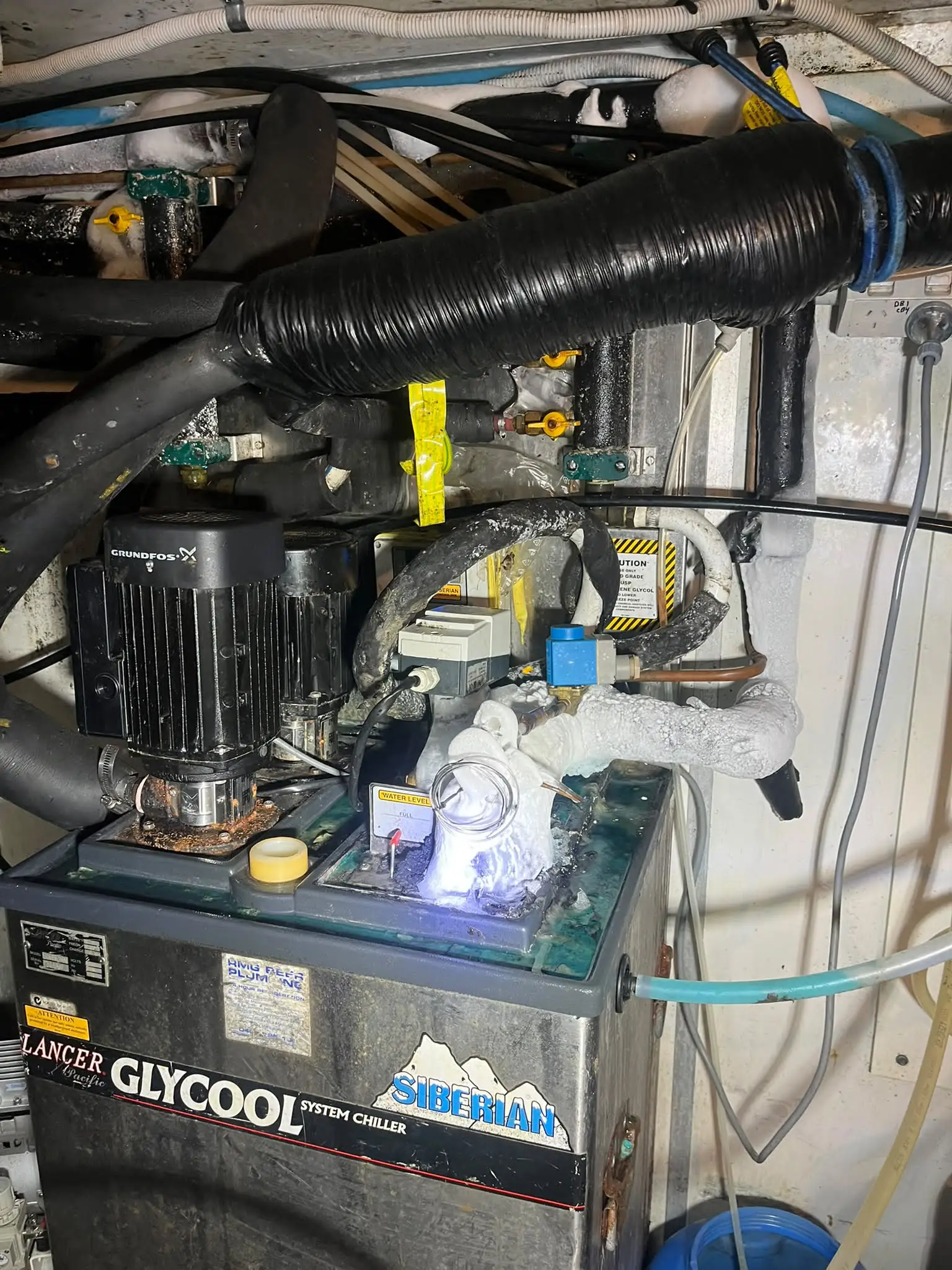 Glycol chiller tank and pump being repaired for a pub beer cooling system