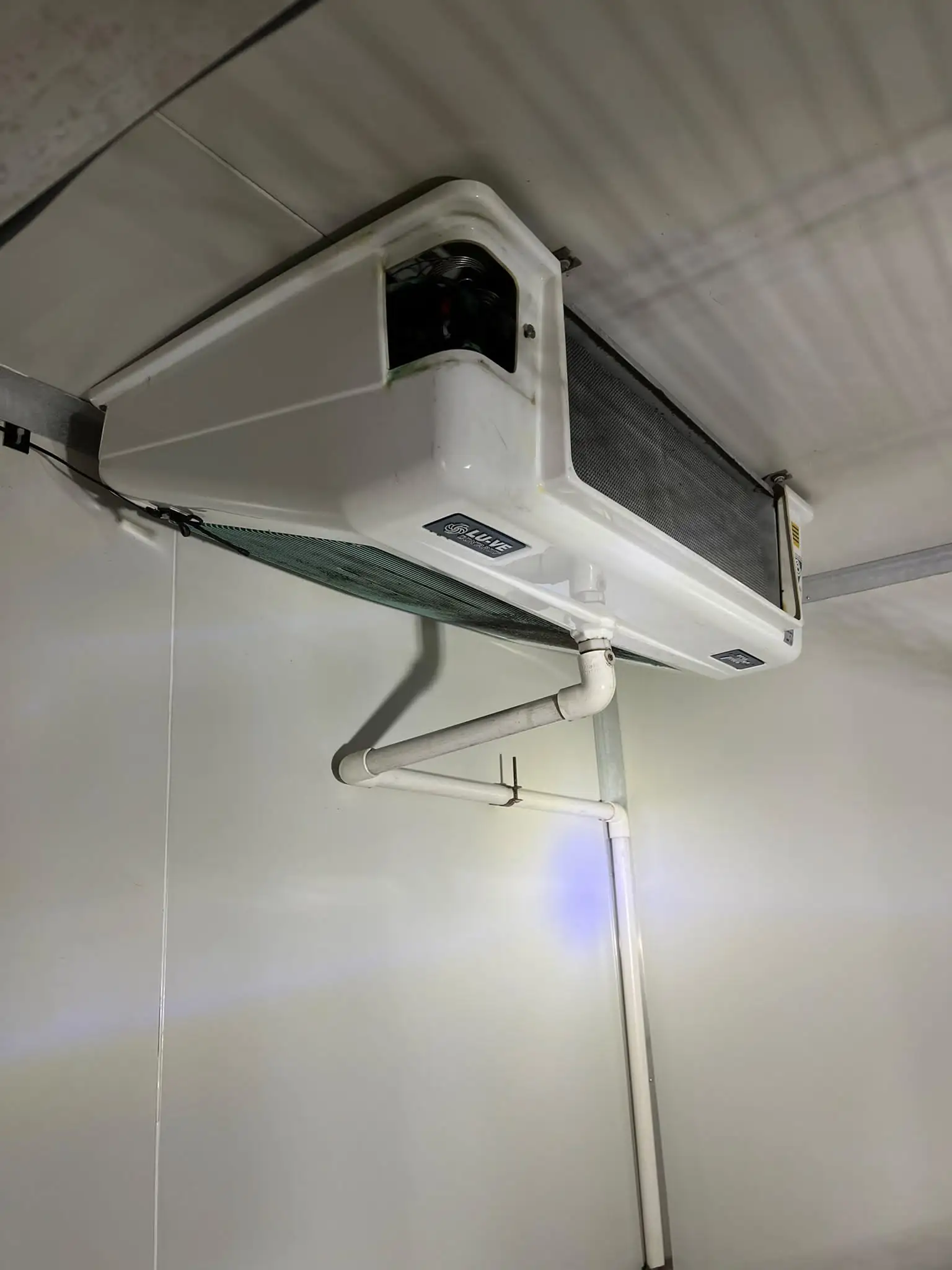 Existing evaporator unit inside a cool room before replacement