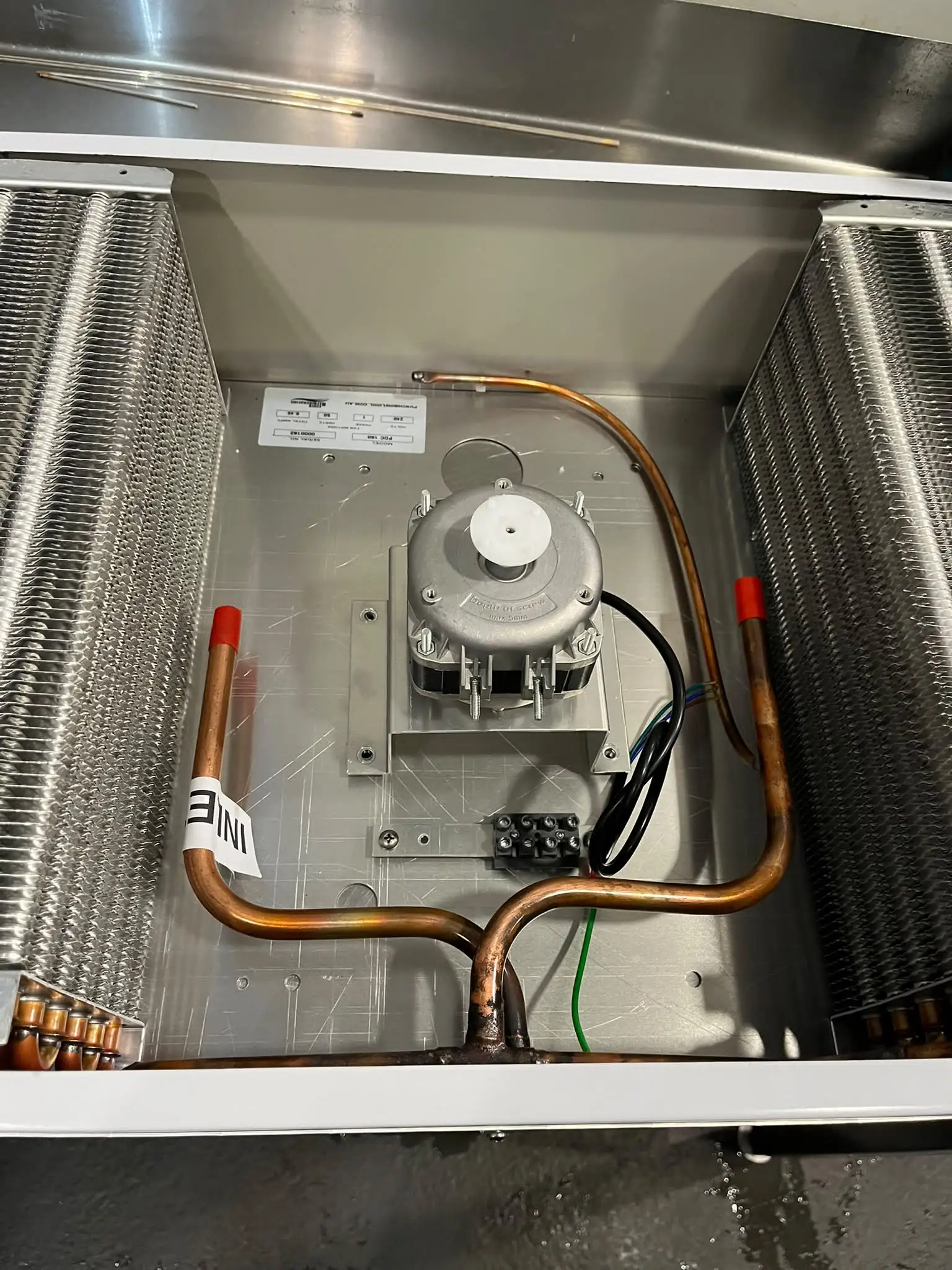 Evaporator assembly being fitted inside an under-bench fridge unit
